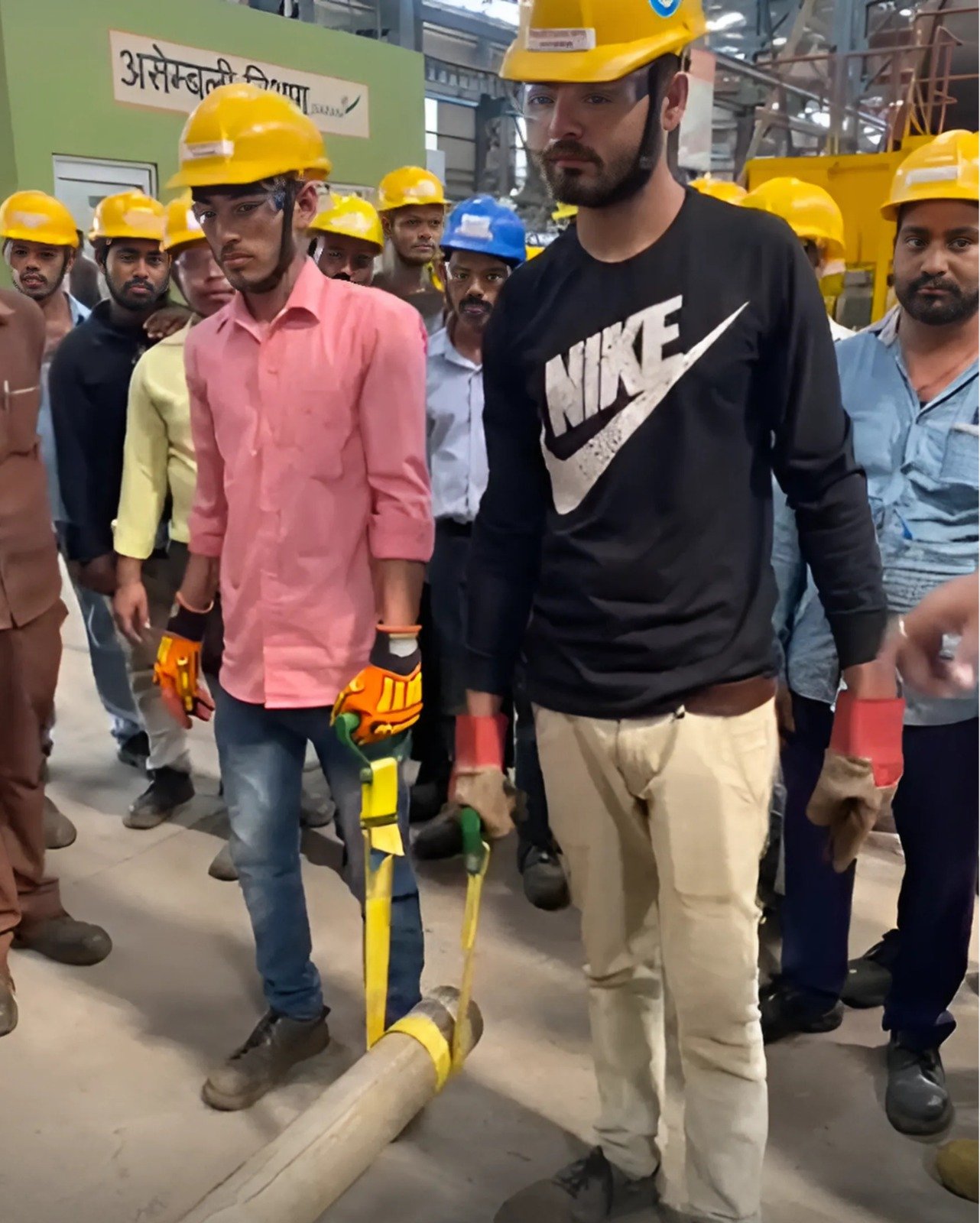 Workers using PSC manual lifting aids to carry a pipe section